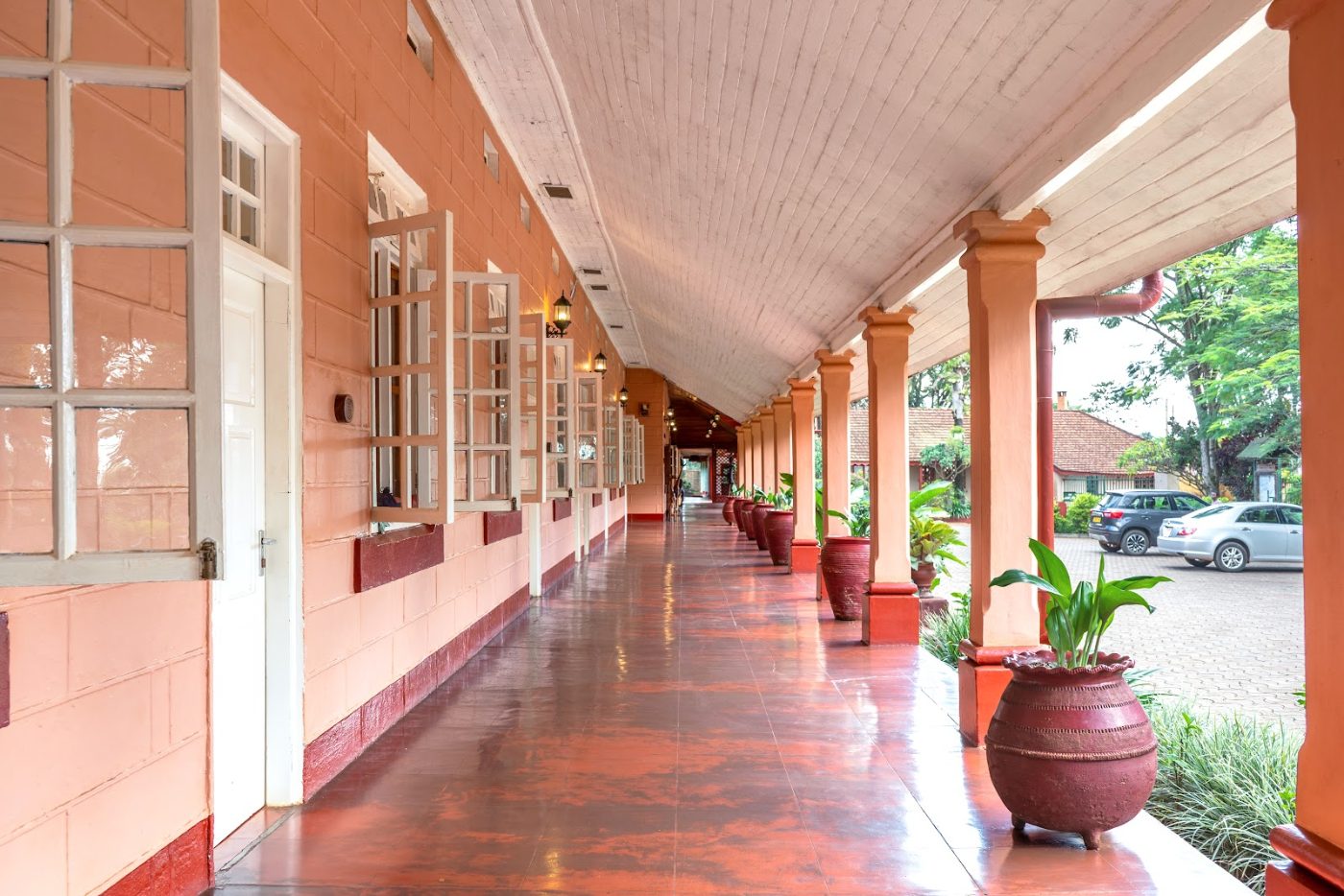 The red-pillared covered walk at Masindi Hotel
