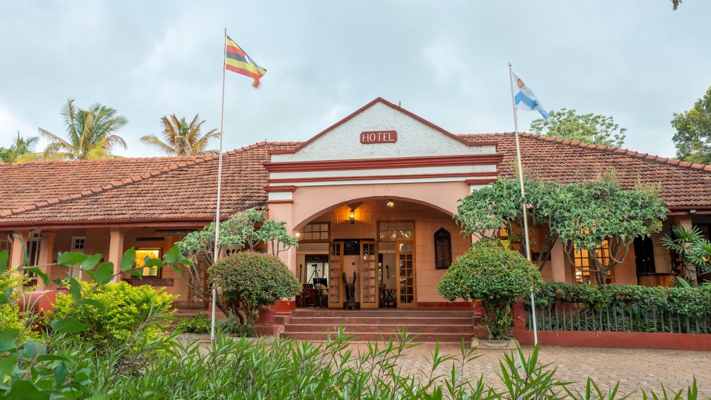 The front of Masindi Hotel, flags flying over the entrance
