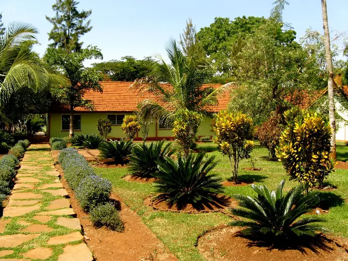 Stone pathway through tropical gardens leading to the Birders Block at Masindi Hotel