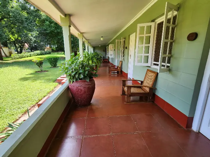 Covered veranda walkway outside the Hemingway Room at Masindi Hotel