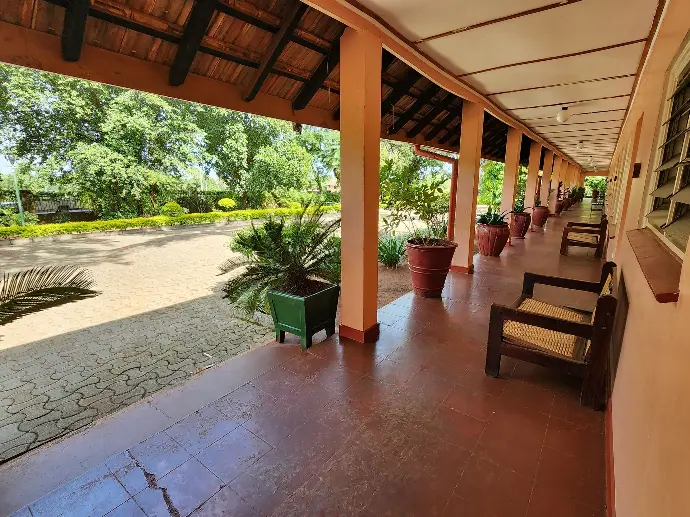 Wooden veranda seating area at the Explorer Block, Masindi Hotel
