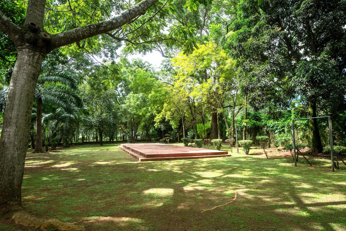 A raised timber camping deck on the lawn at Masindi Hotel