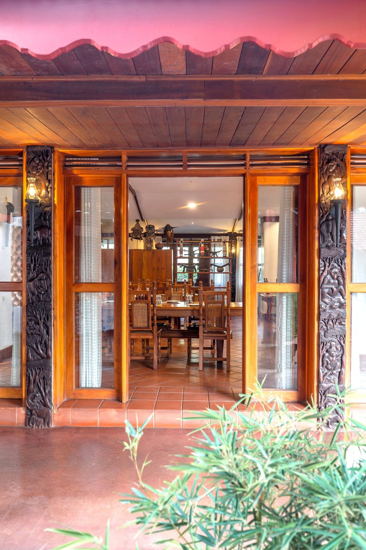 Carved wooden doors into the dining room at Masindi Hotel
